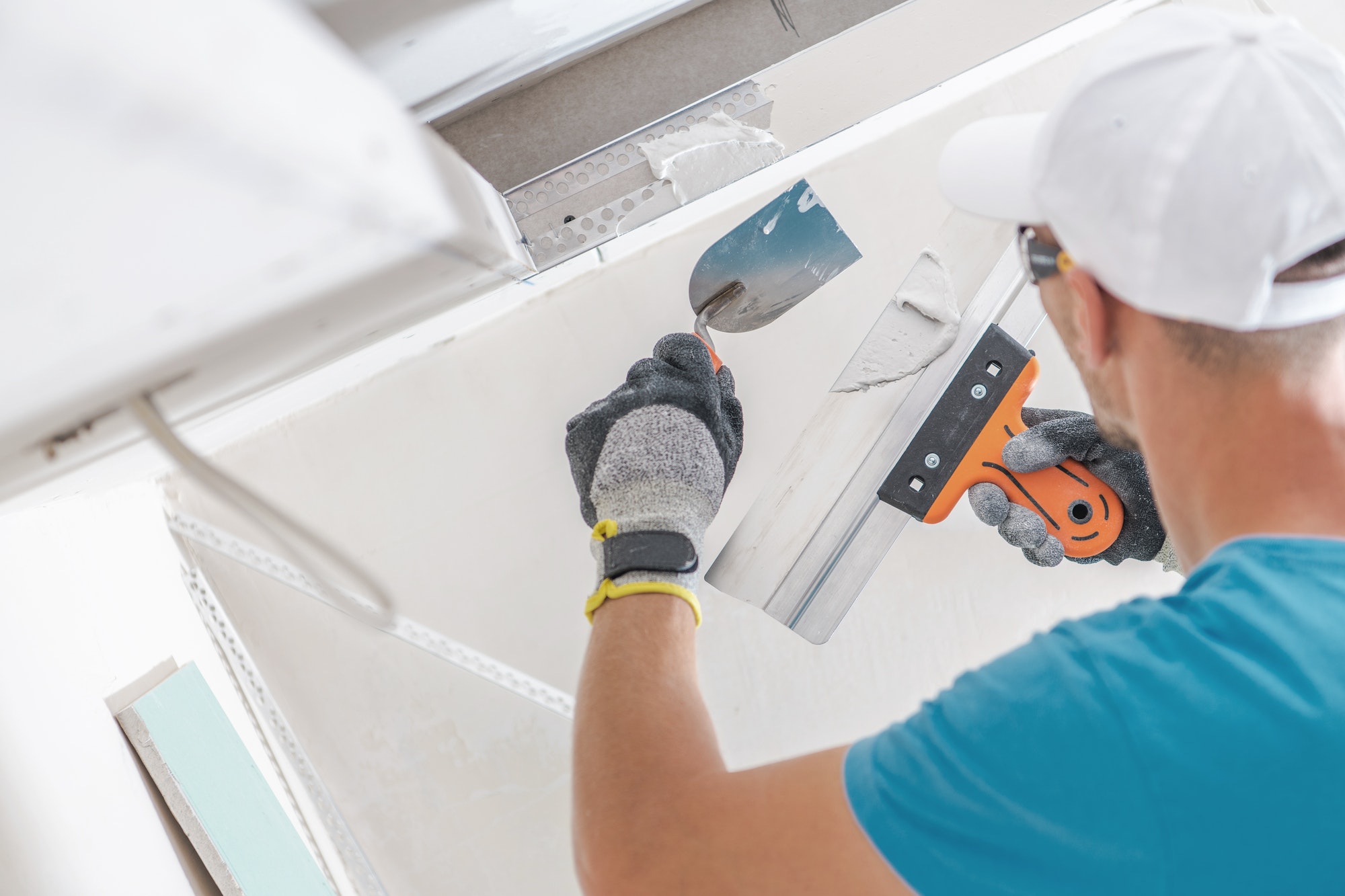 Residential electrician working on drywall ceiling